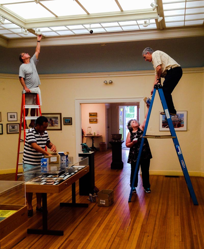 Volunteers installing new LED lights throught gallery